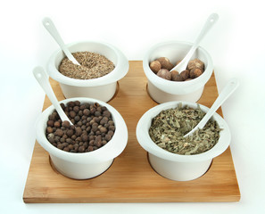 Assortment of spices in  white  bowls,