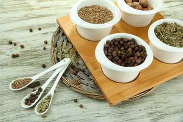 Assortment of spices in  white spoons and bowls,