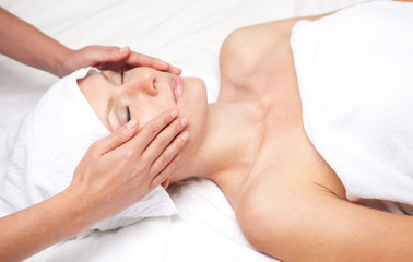 Fototapeta na wymiar Woman getting massaging treatment over white background