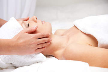 Obraz na płótnie Canvas Woman getting massaging treatment over white background