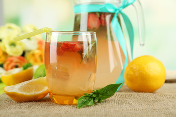 Basil lemonade with strawberry in  jug and glass,
