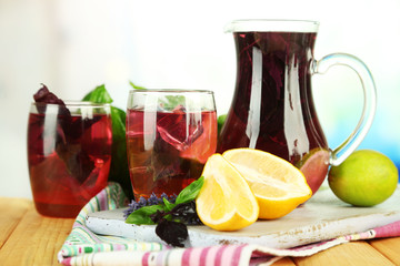 Red basil lemonade in jug and glass,