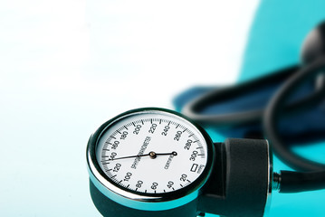 Sphygmomanometer on blue, reflective background