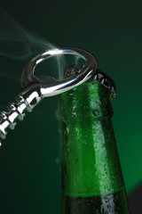 Top of open wet beer bottle on dark background