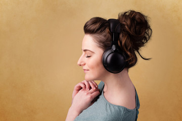 Young woman with headphones listening to music with copy space