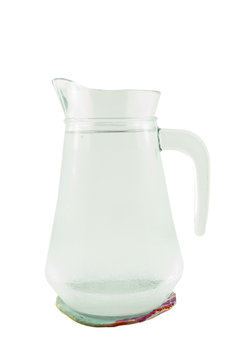 jug of water or glass carafe with coaster on white background