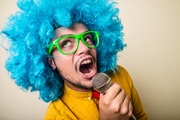 crazy funny young man with blue wig - obrazy, fototapety, plakaty