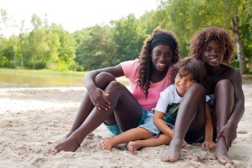 Happy ethnic children in the sand