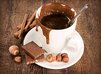 cup of hot chocolate with nuts and cinnamon