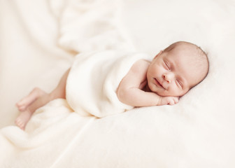 Newborn baby girl asleep on a blanket. - 56360222