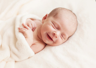 Newborn baby girl asleep on a blanket. - 56360238