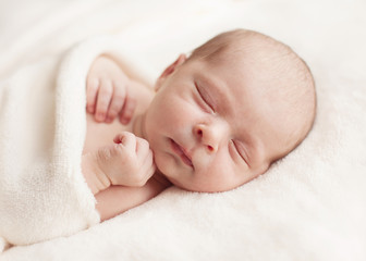 Newborn baby girl asleep on a blanket. - 56360264