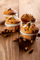 Muffins with almonds on a wooden table