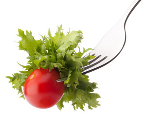 Fresh salad and cherry tomato on fork isolated on white backgrou