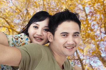 Happy couple at autumn park