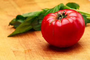 Ripe Tomato and Fresh Basil On Cutting Board