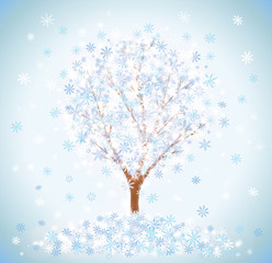 Winter snow-covered tree with snowflakes