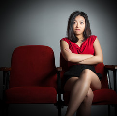 Attractive Asian girl 20s at the theatre isolate white backgroun