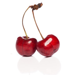 Fresh cherries with leaf isolated on white background