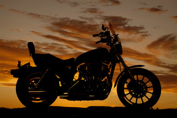 Obraz na płótnie Canvas Silhouette motorcycle side sunset