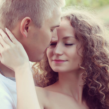 happy young couple kissing and hugging   