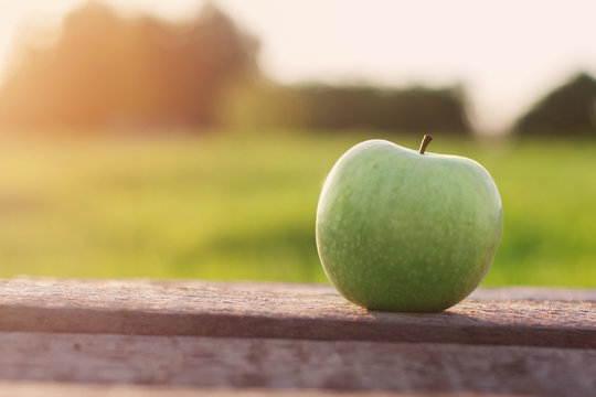 Green Apple On Table Outdoors