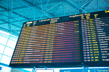Flight information board in airport terminal