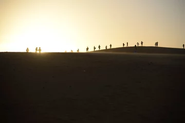  Group of people silhouetted against setting sun © outboundexplorer