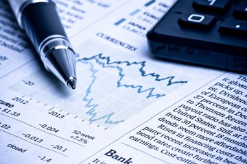 detail of a pen near a calculator