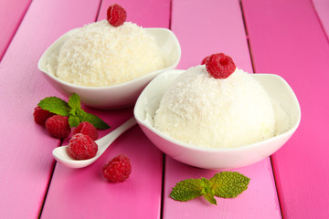 Delicious coconut cakes in bowls on table close-up
