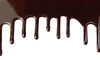 Melted chocolate dripping on white background