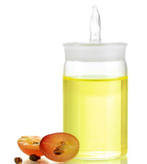 Ripe sliced grape and grapeseed oil, isolated on white