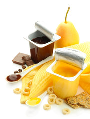 Tasty desserts in open plastic cups and fruits and flakes