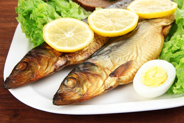 Smoked fish on plate close up