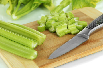 Fresh green celery on cutting board close-up