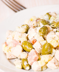 salad with chicken, ham, potatoes and olives