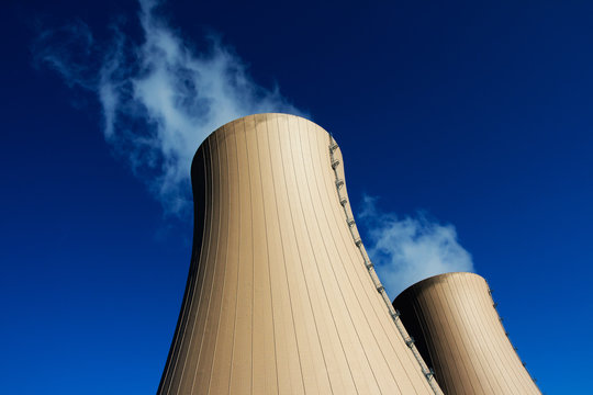 Cooling towers of nuclear power plant against  blue sky