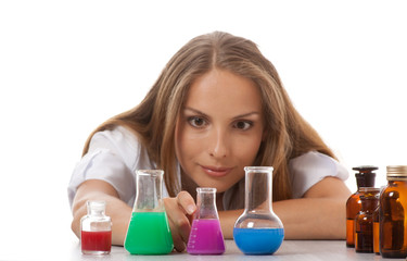 Woman chemist and chemicals in flasks