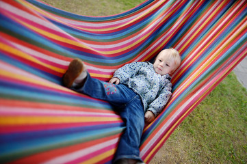 Fototapeta na wymiar Lovely girl resting in a hammock