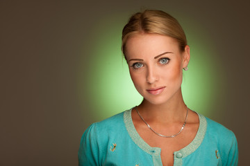 Beauty portrait of attractive young woman with green aura in bac