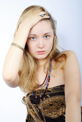 Portrait of the beautiful girl in costume jewellery