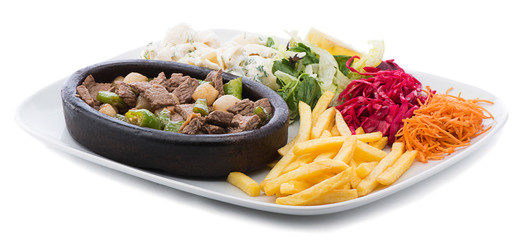 Lamb casserole on a terracotta plate with salad and pasta
