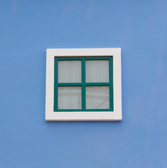 Green window on the blue wall