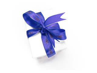 Christmas present wrapped with a blue ribbon and bow.