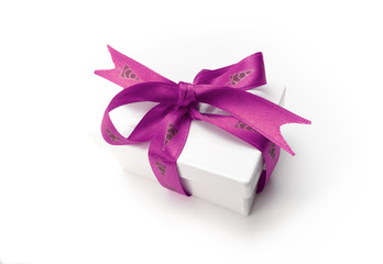 Christmas present wrapped with a pink ribbon and bow.