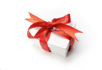 Christmas present wrapped with a red ribbon and bow.