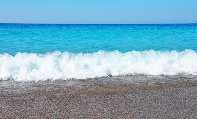 Fototapeta na wymiar sea beach, blue sky, waves, pebble
