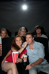 Friends watching movie at cinema