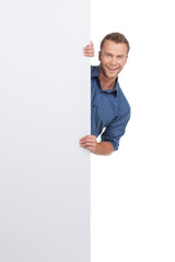 Cheerful man. Cheerful young man looking out of the poster and s