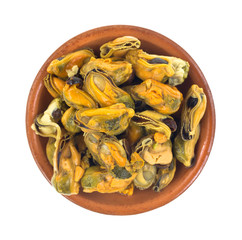 Several marinated mussels in a small red clay bowl